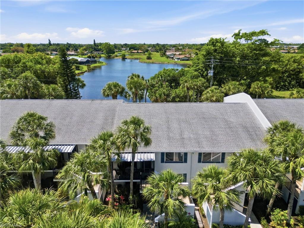 Multi-level residential structure featuring a gray shingle roof and white exterior siding
