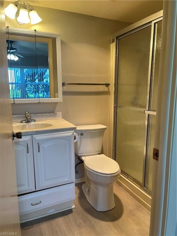 Bathroom featuring a white vanity with a light-colored countertop, an integrated sink, and a mirrored medicine cabinet