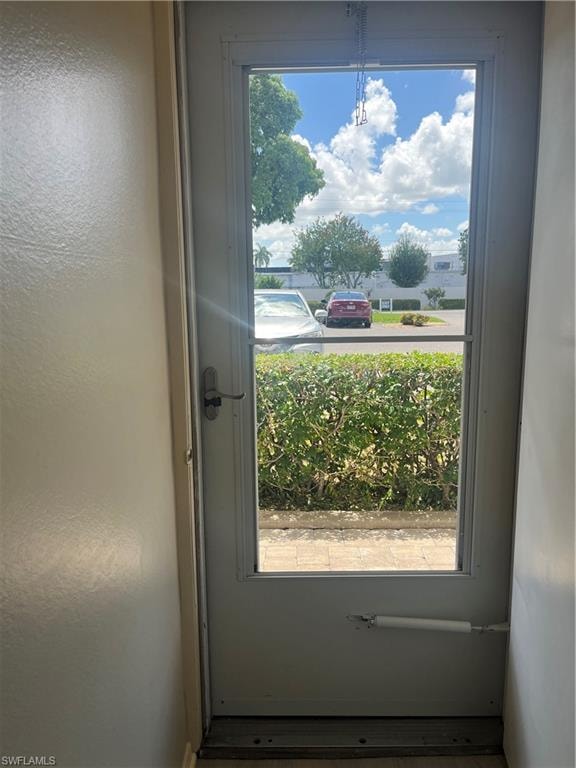 White exterior door with a full-light window