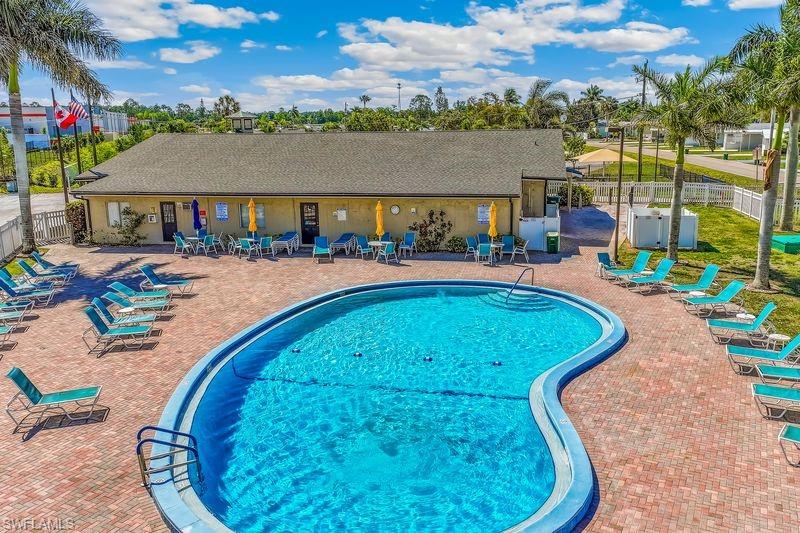 Aerial view of the community swimming pool featuring an integrated entry stair, surrounded by a paver patio.