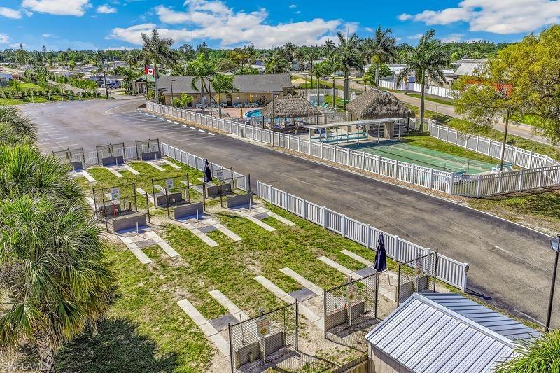 Community amenities featuring a shuffleboard court, horseshoe pits, fenced swimming pool, and an outdoor tiki-style structure