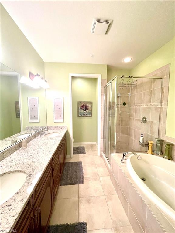 Primary Bathroom with tub and double vanity
