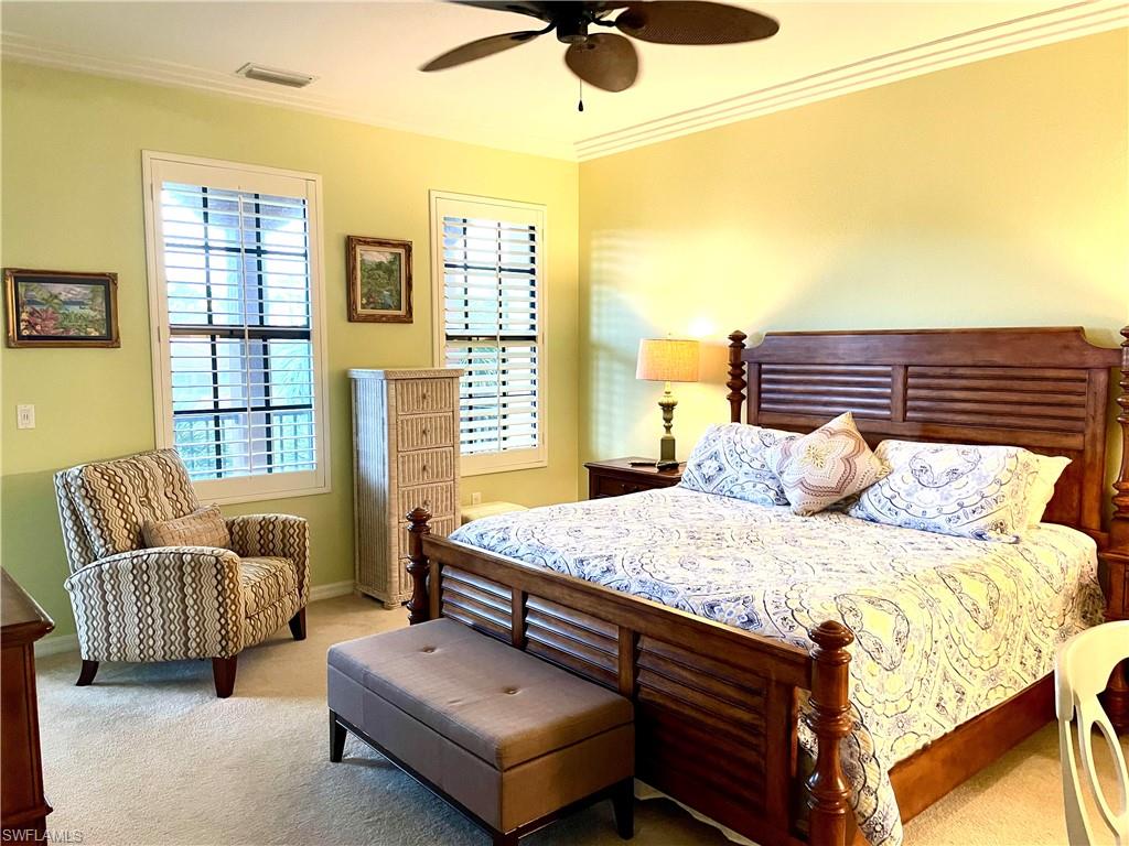 Primary bedroom with king size bed and pool view