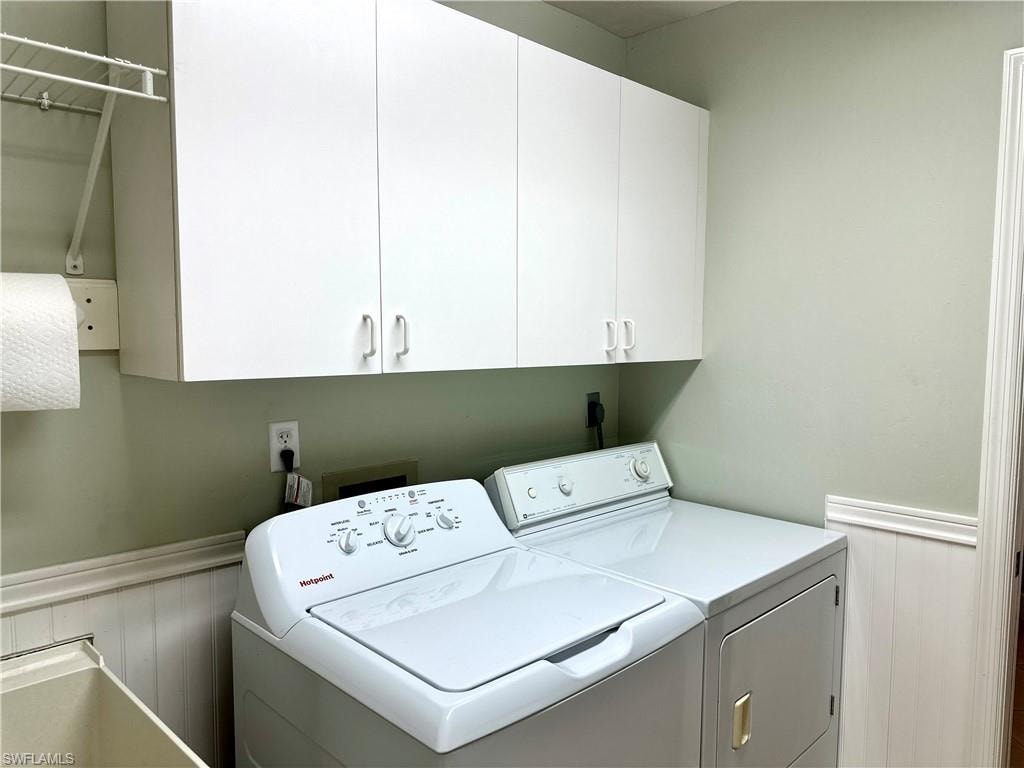 The laundry room includes storage cabinets and a laundry sink.