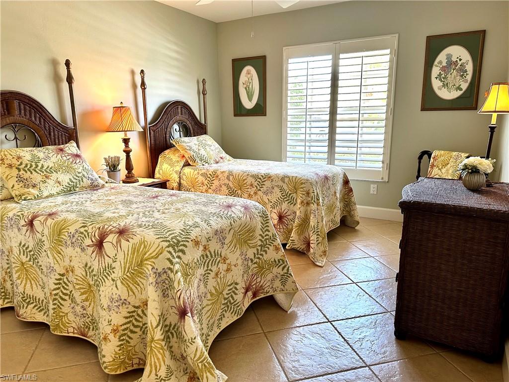 Bedroom no. 3 is furnished with twin beds.  It has an Island or Tommy Bahama vibe.