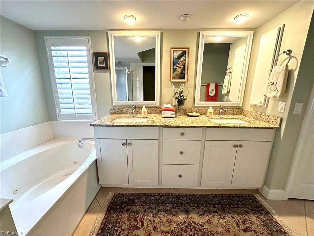 The vanity is updated, and features granite, double sinks and plenety of storage.