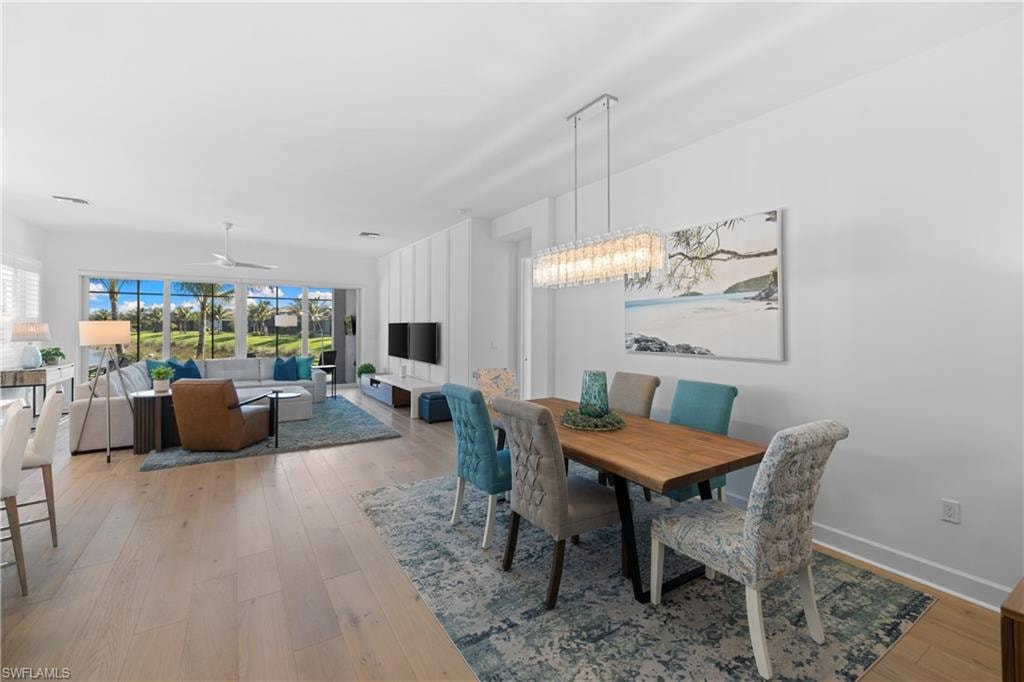Open-concept living and dining area featuring light wood-finish flooring
