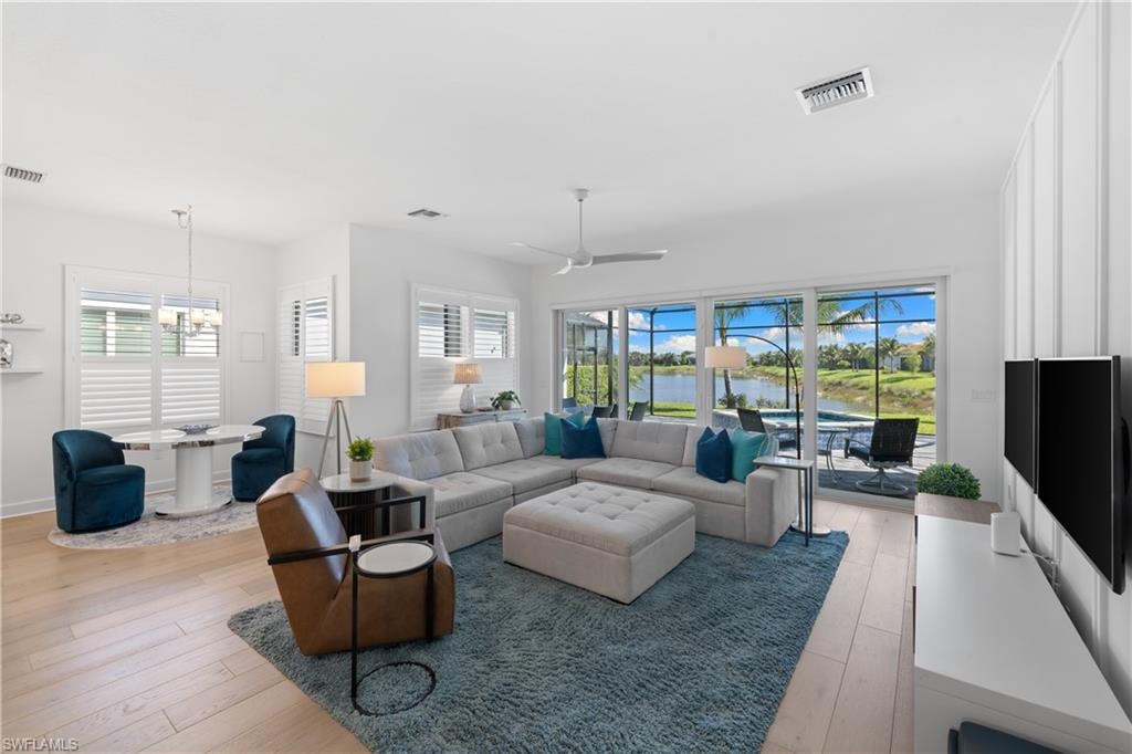 Open-concept living space featuring wood-finish flooring and ample natural light