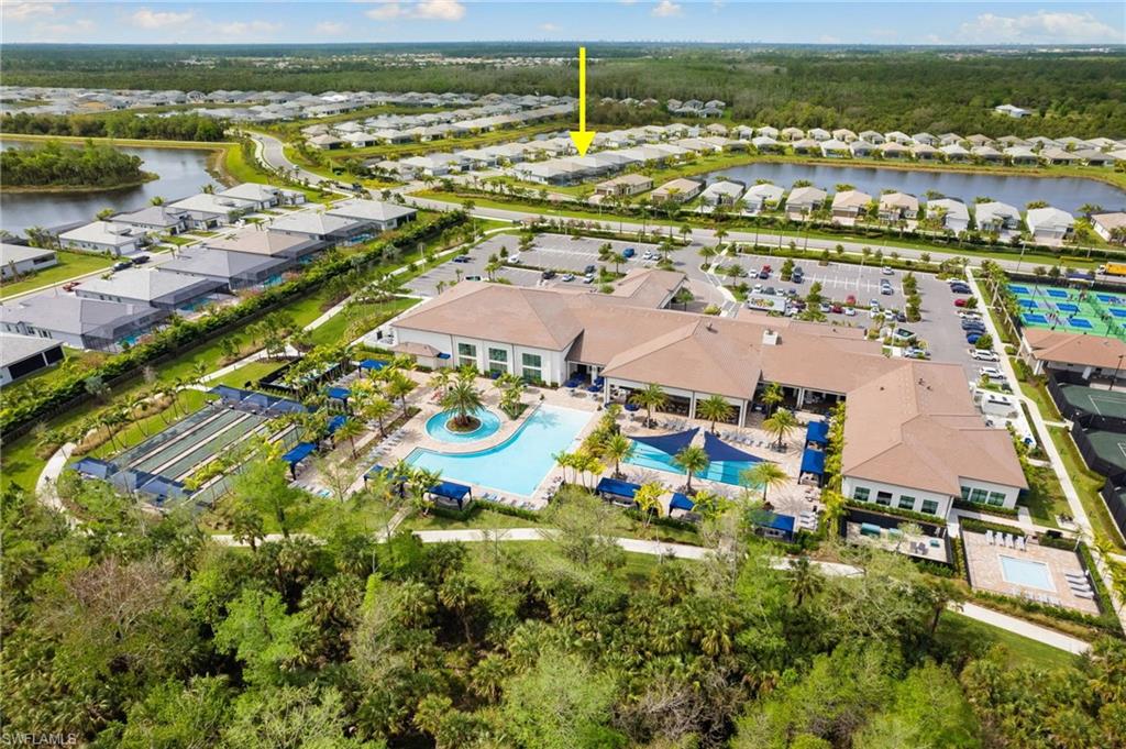 Community clubhouse featuring a large swimming pool that is located within a very short walking distance.