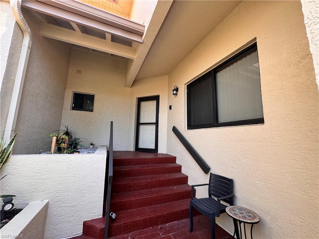 Entryway featuring textured stucco walls and a covered porch