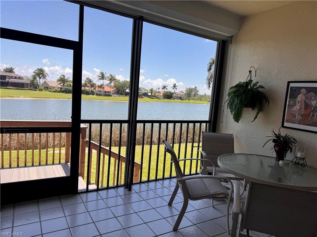 Screened patio with large format tile flooring and a water backdrop