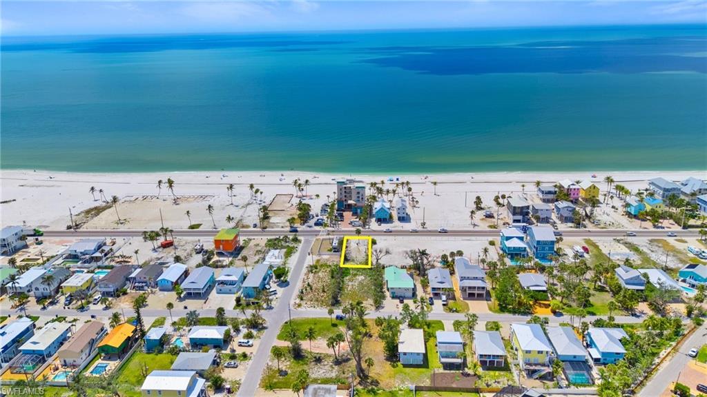 Drone / aerial view with a water view, a residential view, and a beach view  - Virtually Edited Image