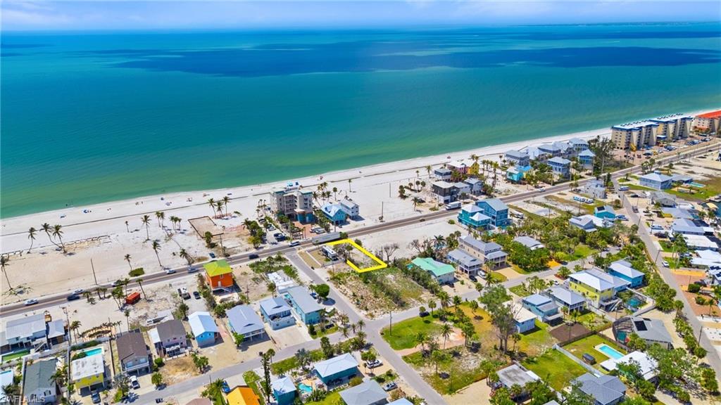 Birds eye view of property with a water view and a beach view  - Virtually Edited Image