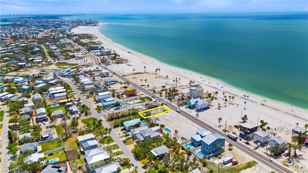 Birds eye view of property featuring a view of the beach and a water view  - Virtually Edited Image