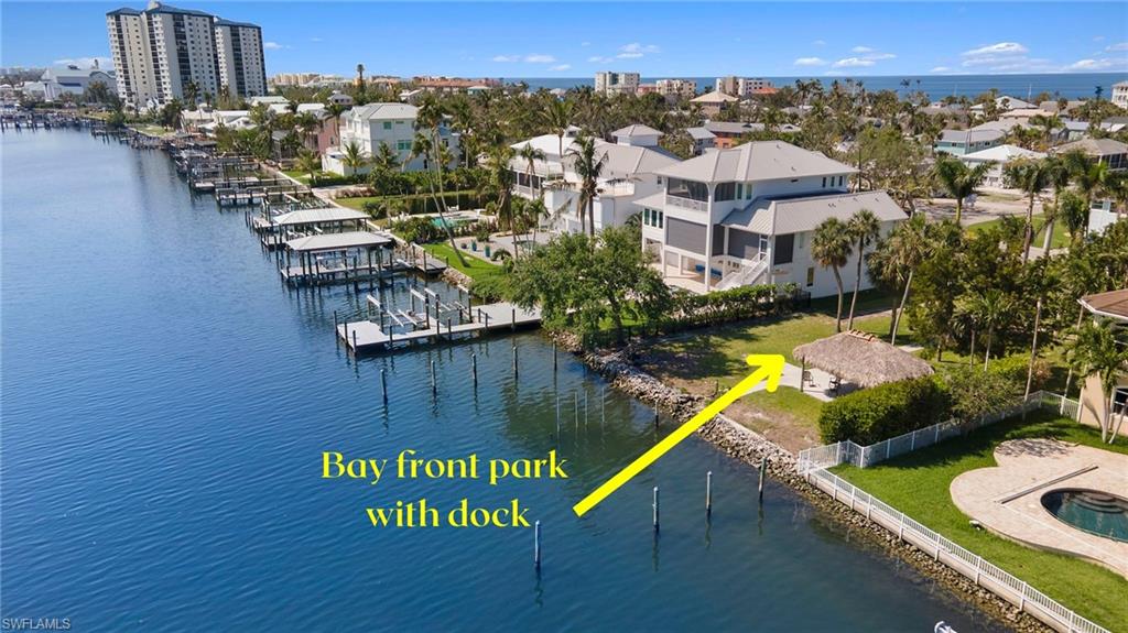 PRIVATE BAYFRONT PARK FOR NEIGHBORHOOD Birds eye view of property with a water view and a residential view - - VIRTUALLY EDITED IMAGE