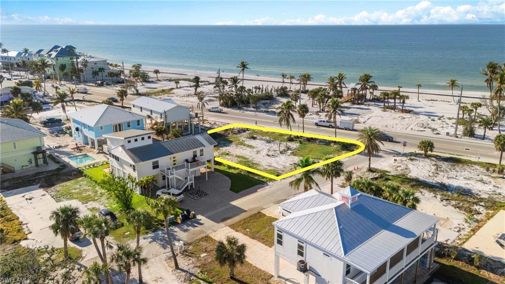 Aerial view with a water view and a view of the beach VIRTUALLY EDITED