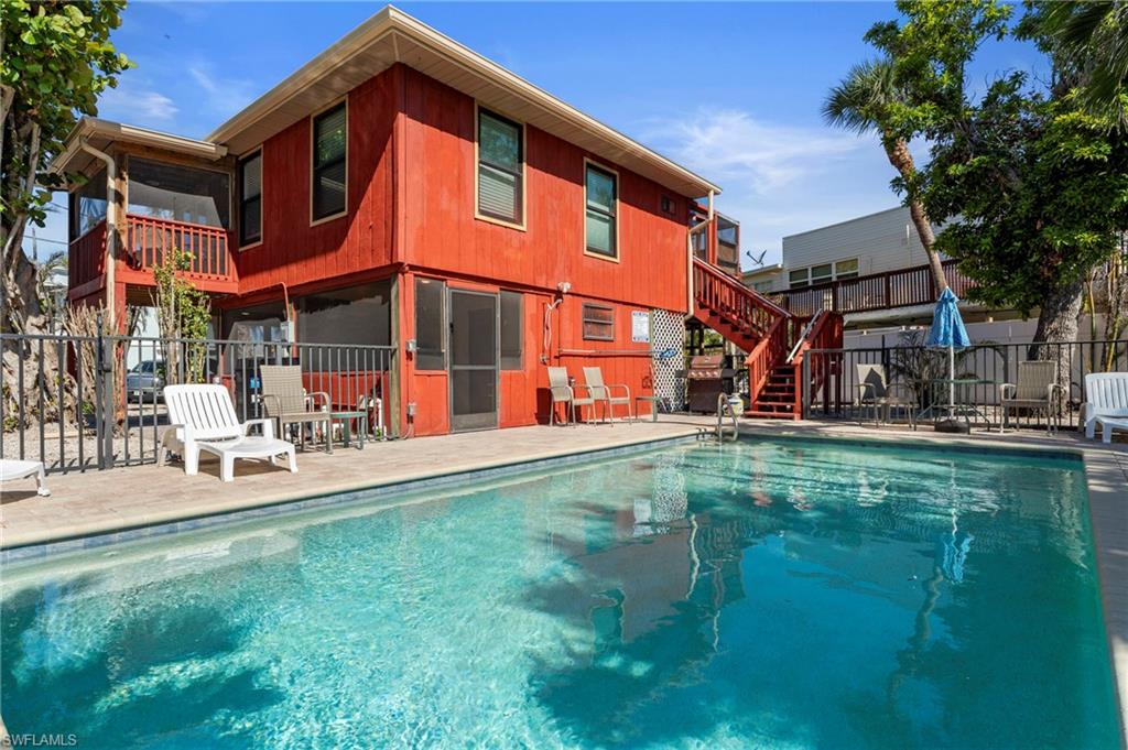 Ready to go swimming? - View of pool featuring fence, a patio area, a fenced in pool, and stairs - Virtually Edited Exterior Image