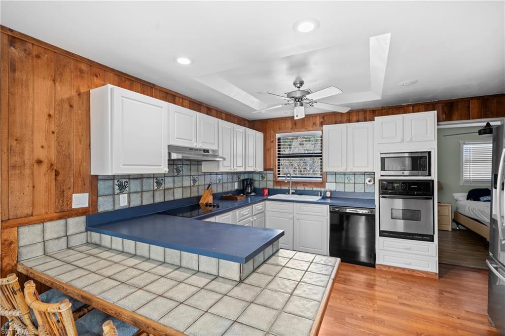 Kitchen with ample cabinet space and modern appliances  - Virtually Edited Image