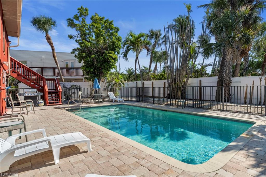 Sparkling pool and a charming paver deck - Virtually Edited Exterior Image