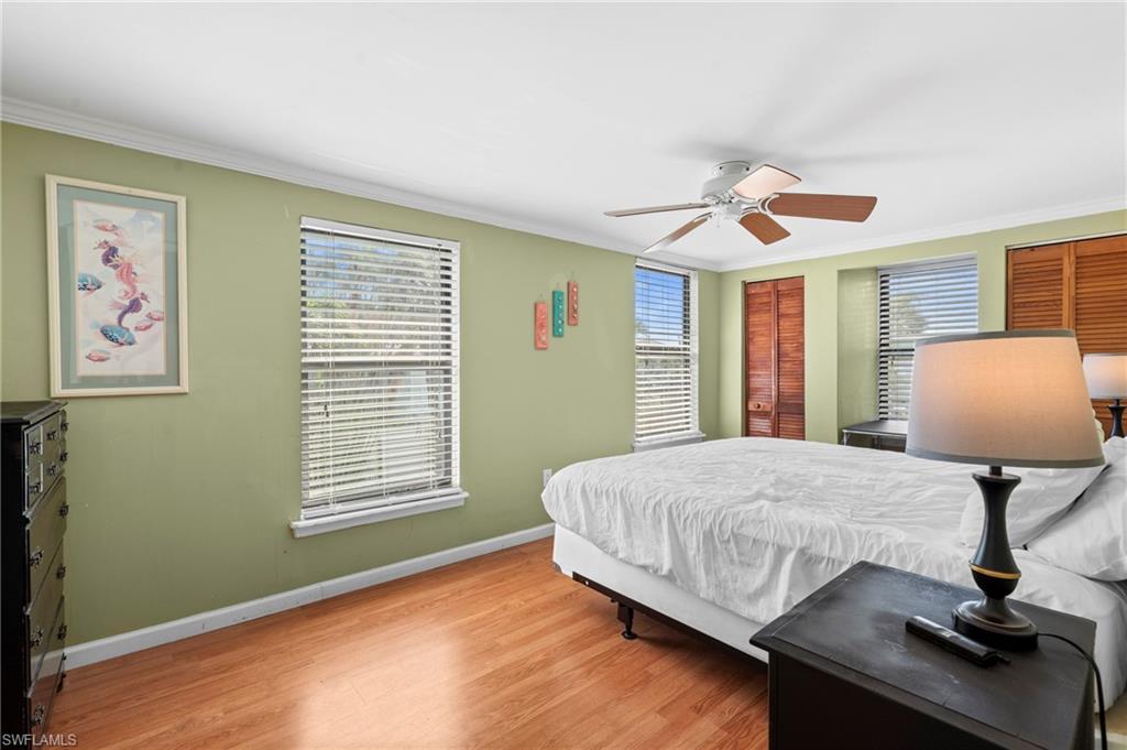 Bedroom with large windows and ample closet space - Virtually Edited Image