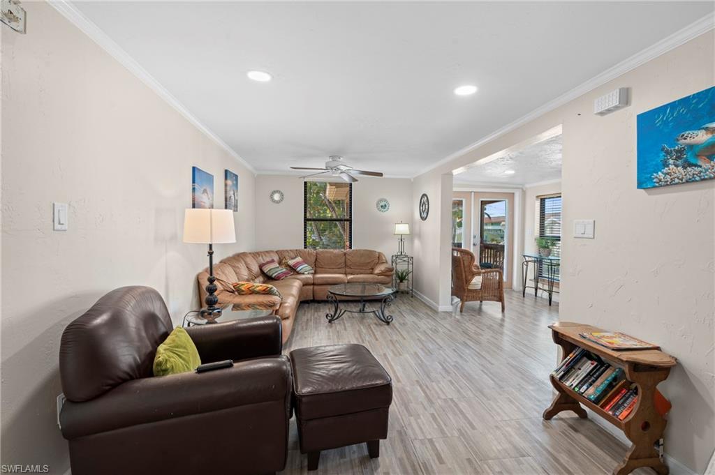 Living room with cozy seating and an open layout that connects effortlessly to the dining space - Virtually Edited Image