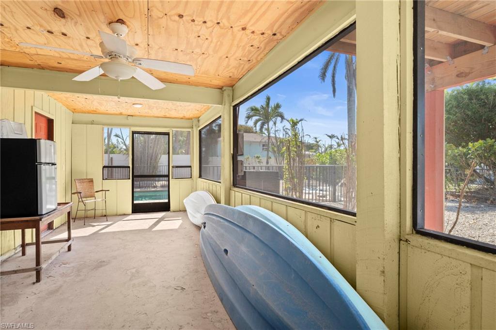 Screened-in storage or utility area, ideal for stashing beach gear, kayaks, and outdoor essentials  - Virtually Edited Image