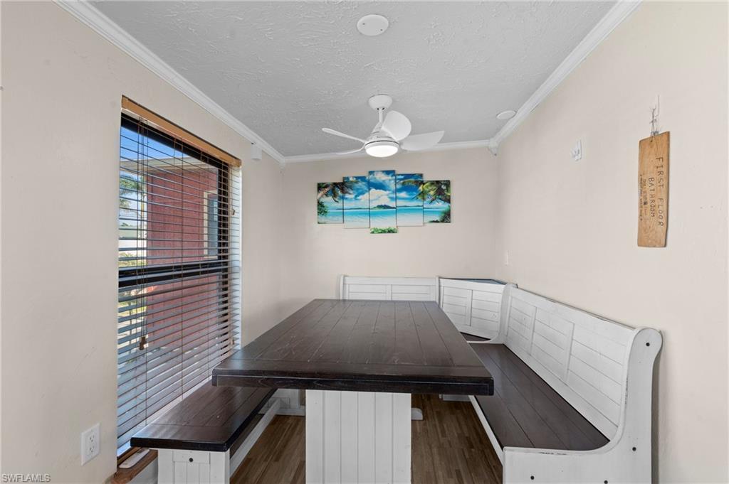 Dining area features a built-in corner bench with natural light offering a cozy and inviting spot for meals  - Virtually Edited Image