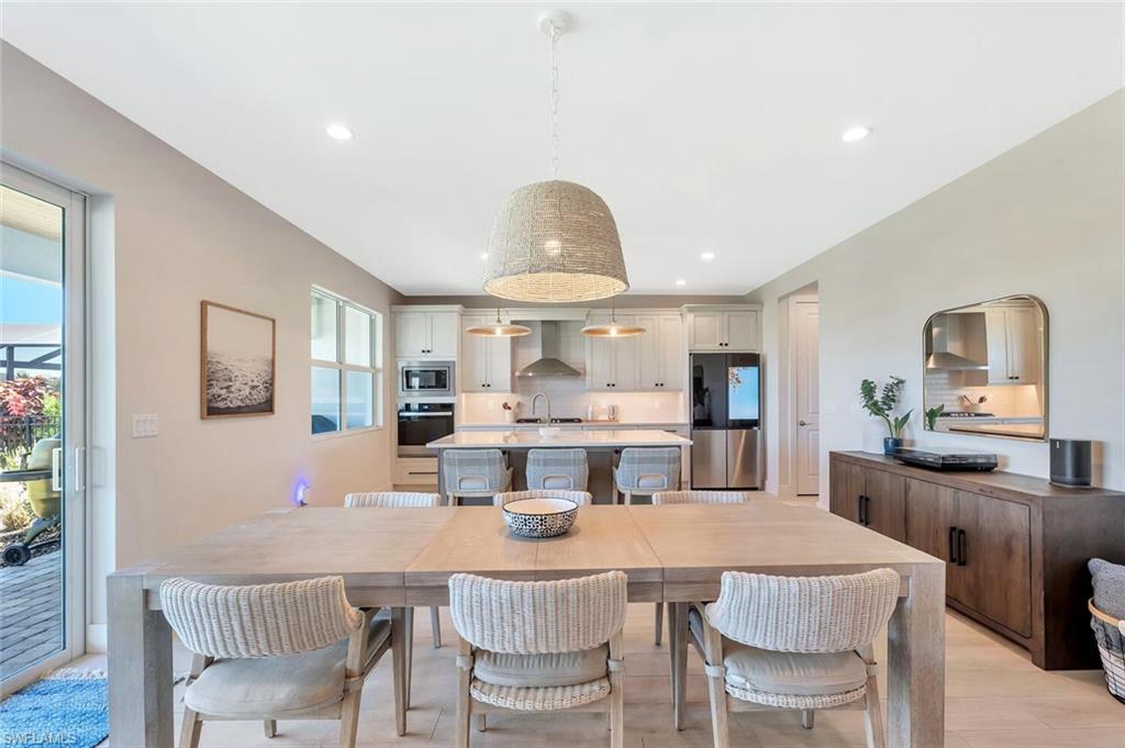 This open-concept living and dining area blends modern design with relaxed elegance. Warm wood tones, soft neutral walls, and natural light create a welcoming flow between the dining table, lounge space, and kitchen beyond. Clean lines and layered textures make it perfect for both casual gatherings and stylish entertaining—a space that feels effortlessly connected and inviting.