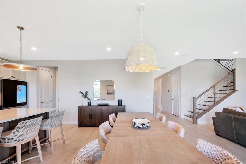 This open-concept living and dining area blends modern design with relaxed elegance. Warm wood tones, soft neutral walls, and natural light create a welcoming flow between the dining table, lounge space, and kitchen beyond. Clean lines and layered textures make it perfect for both casual gatherings and stylish entertaining—a space that feels effortlessly connected and inviting.