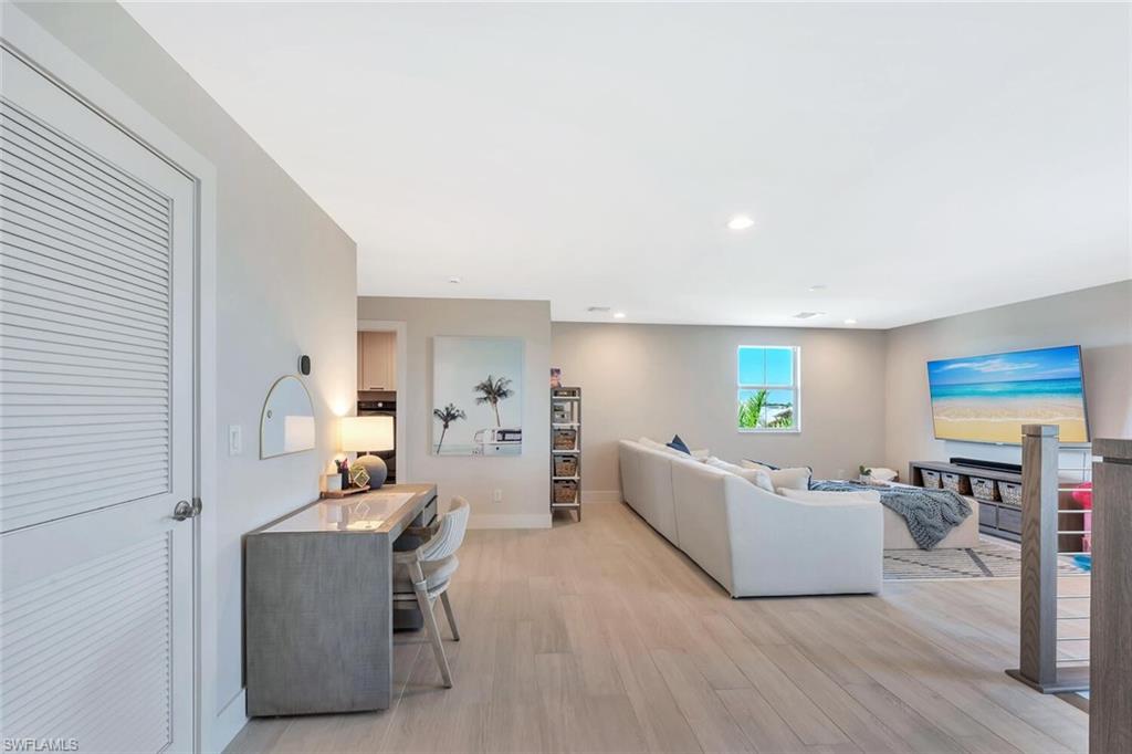 This open-concept living and dining area blends modern design with relaxed elegance. Warm wood tones, soft neutral walls, and natural light create a welcoming flow between the dining table, lounge space, and kitchen beyond. Clean lines and layered textures make it perfect for both casual gatherings and stylish entertaining—a space that feels effortlessly connected and inviting.