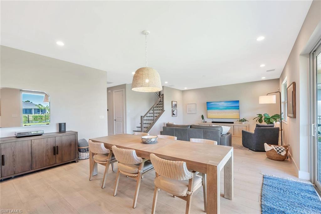 This open-concept living and dining area blends modern design with relaxed elegance. Warm wood tones, soft neutral walls, and natural light create a welcoming flow between the dining table, lounge space, and kitchen beyond. Clean lines and layered textures make it perfect for both casual gatherings and stylish entertaining—a space that feels effortlessly connected and inviting.