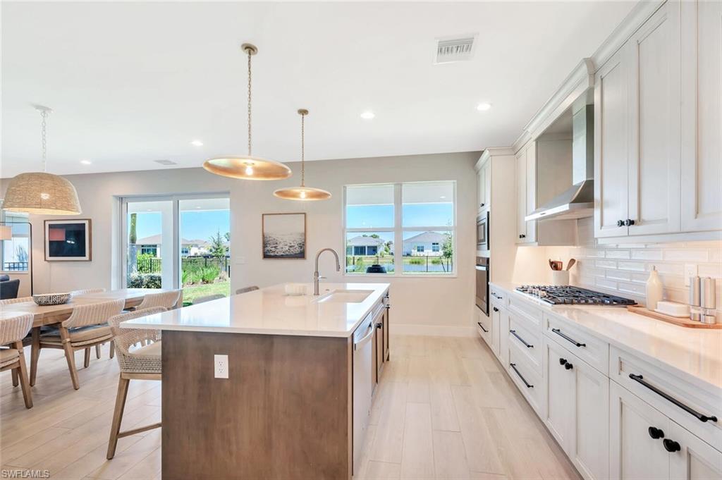This kitchen pairs sleek functionality with modern farmhouse charm. Crisp white cabinetry, designer hardware, and stainless-steel appliances create a bright, polished look. A custom range hood, built-in oven and microwave, and quartz counters complete the space—clean, efficient, and made for both everyday living and effortless entertaining.