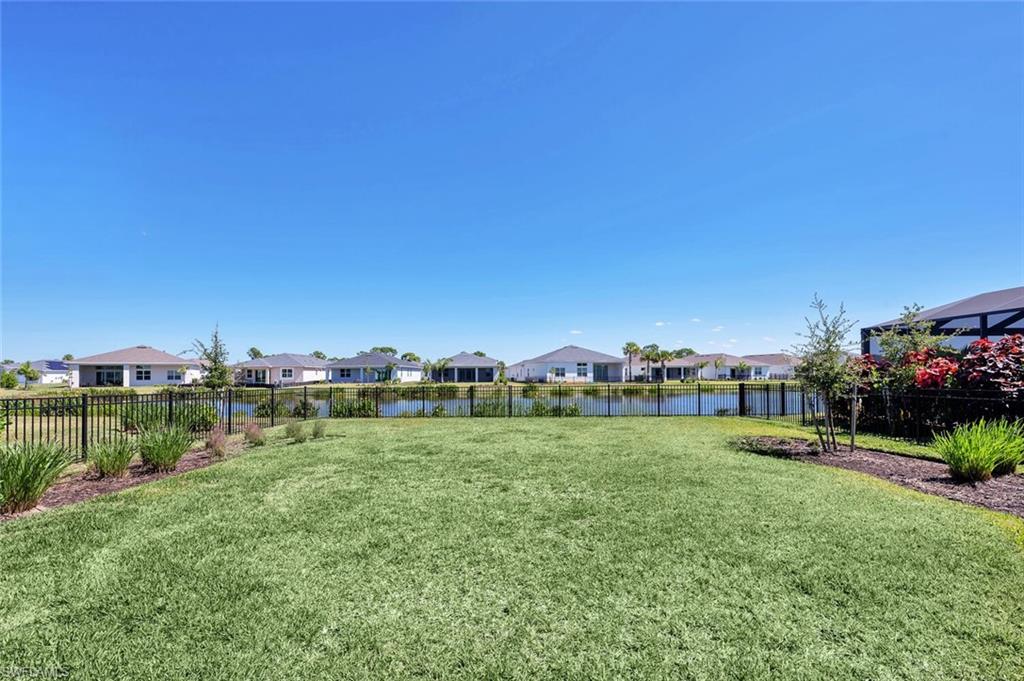 Expansive fenced east-facing yard with serene lake views—perfect for your dream pool and pets.