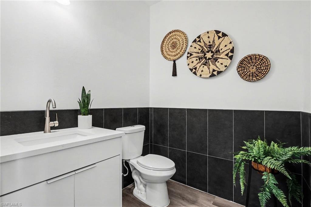 Bathroom with a white vanity featuring an integrated sink and brushed nickel faucet