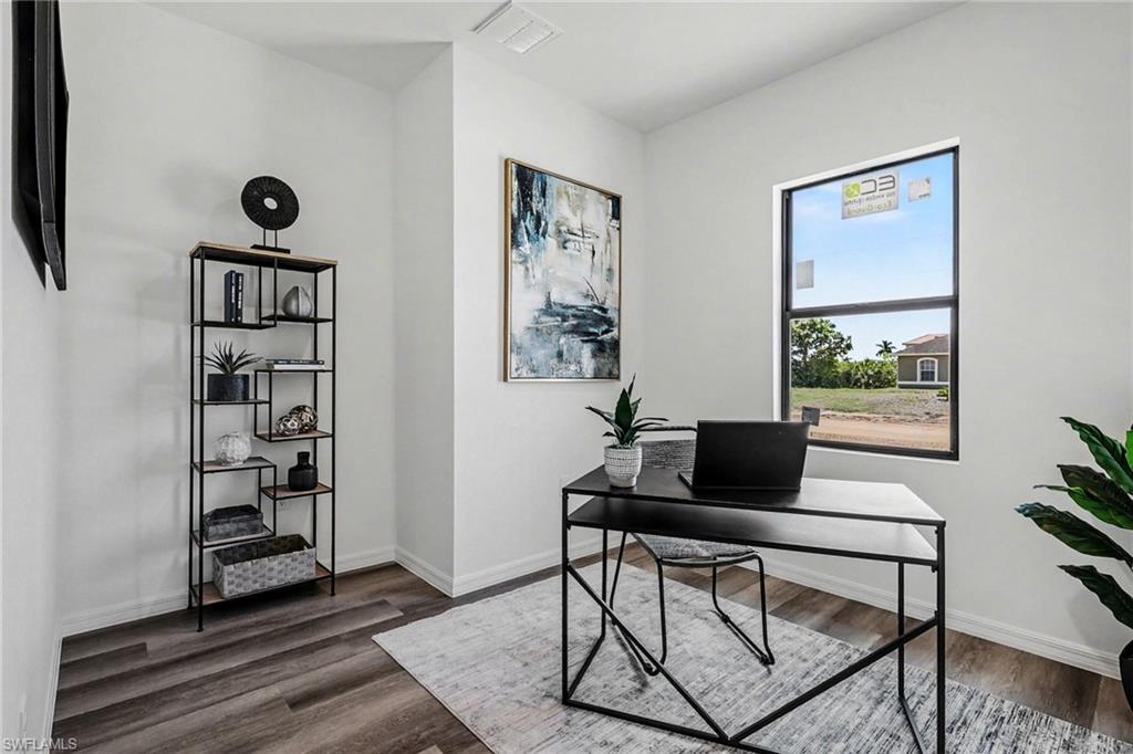 Dedicated room featuring wood-finish flooring, a large window, white walls, and recessed lighting