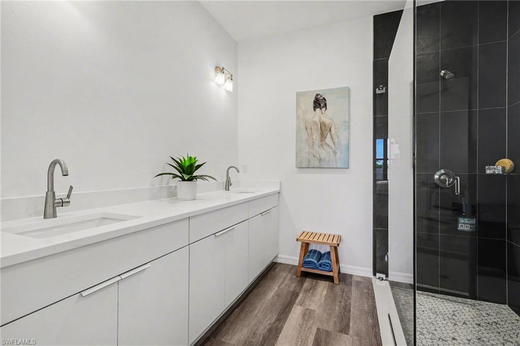 Bathroom featuring a dual vanity with undermount sinks and modern brushed nickel faucets