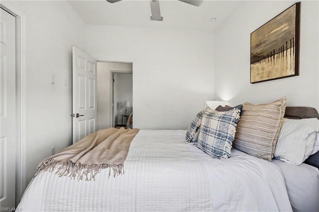 White painted walls with recessed lighting and a ceiling fan