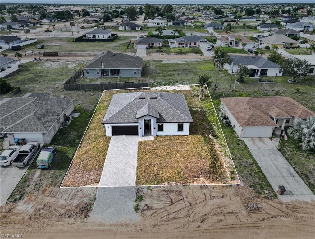 Contemporary single-story residence featuring a dark gray shingle roof and a two-car garage