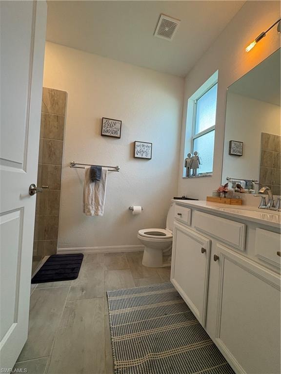 Bathroom featuring a single vanity with white cabinetry, light-toned countertop, and a chrome faucet