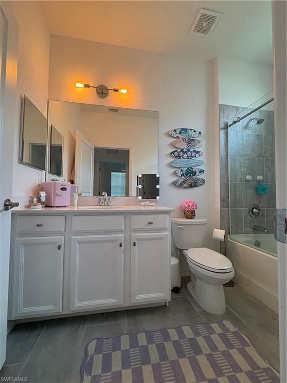 Full bathroom featuring a white vanity with integrated sink, overhead lighting, a tub/shower combination with subway tile surround, and tile flooring