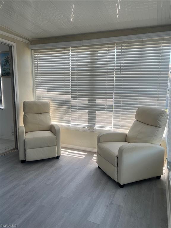 Sitting room featuring baseboards and wood finished floors