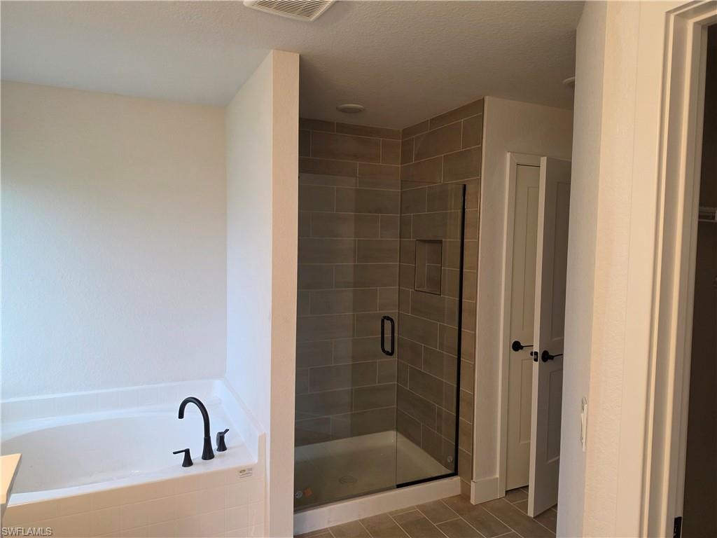Contemporary bathroom featuring a walk-in shower with clear glass enclosure and built-in tile niche