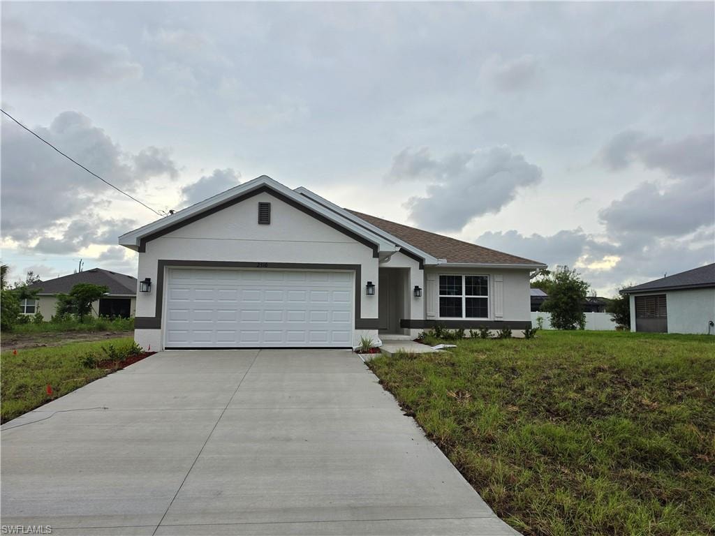Contemporary single-story residence featuring a two-car garage with a panel door