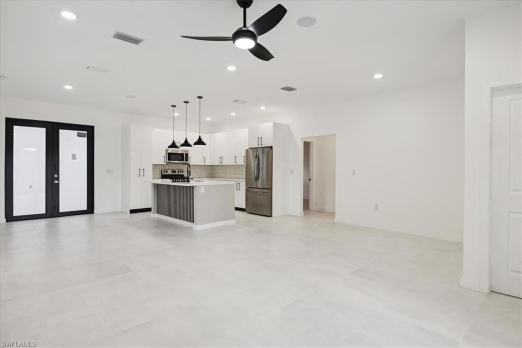 Unfurnished room with a ceiling fan and recessed lighting