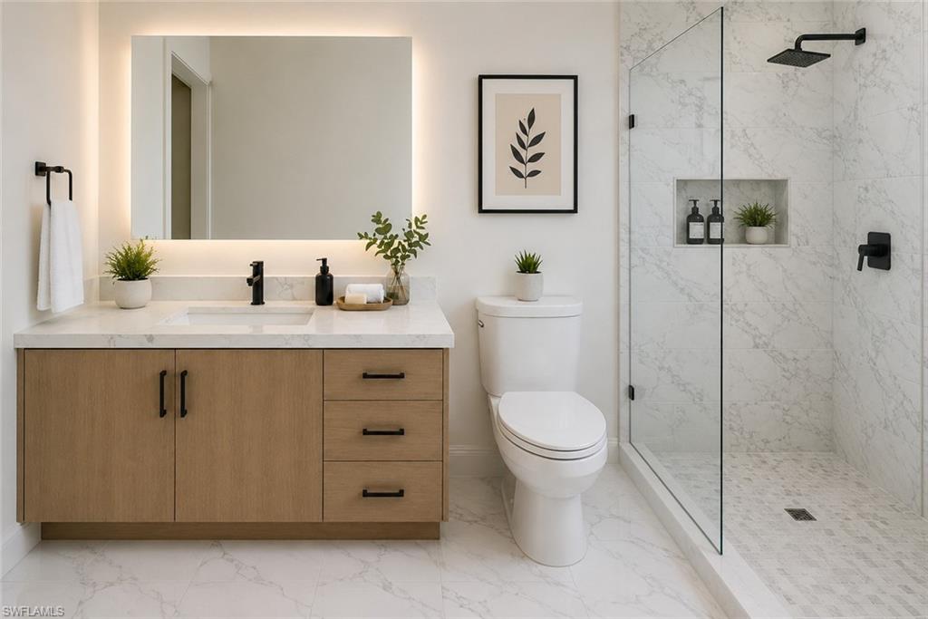 Contemporary bathroom featuring a light wood-finish vanity with matte black hardware, an illuminated mirror, and a walk-in shower with a glass enclosure