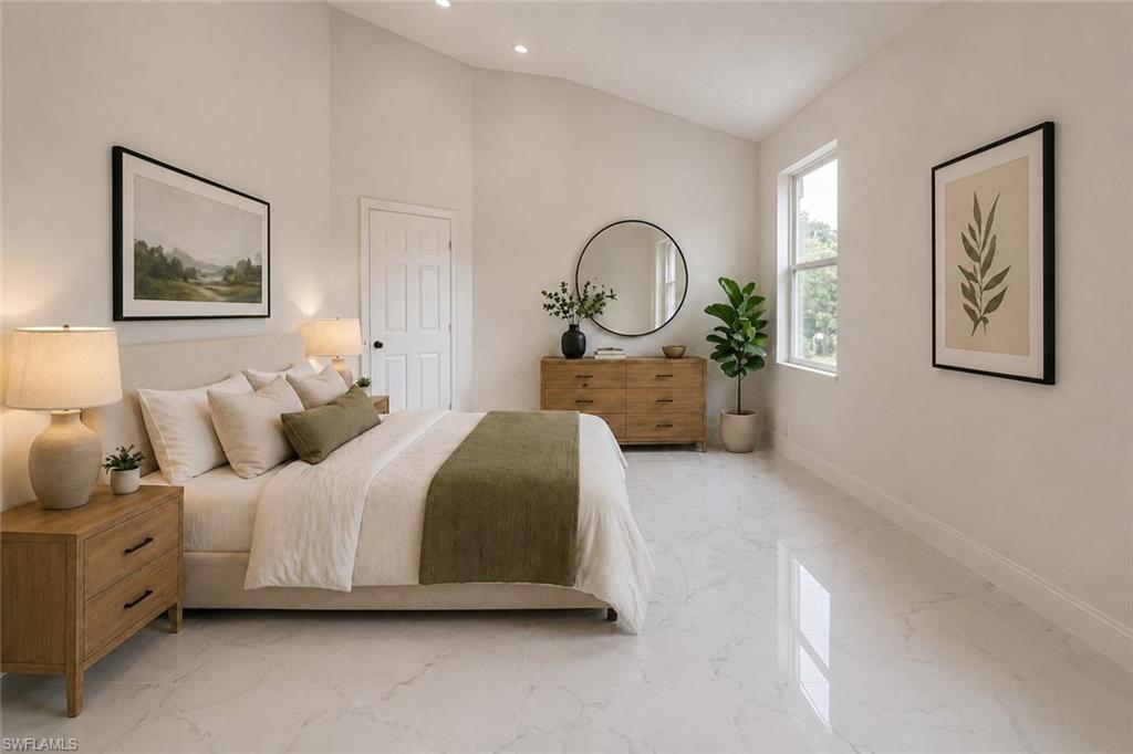 Spacious room featuring vaulted ceilings, recessed lighting, white marble-look flooring, a large window, and a paneled interior door. Image digitally enhanced and virtually altered; actual property condition may differ..