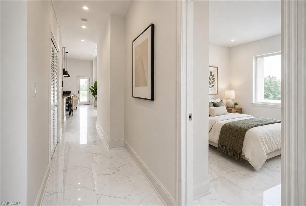 Bright hallway with tile flooring, featuring a bedroom with a window and a glimpse of a kitchen with pendant lighting. Image digitally enhanced and virtually altered; actual property condition may differ..