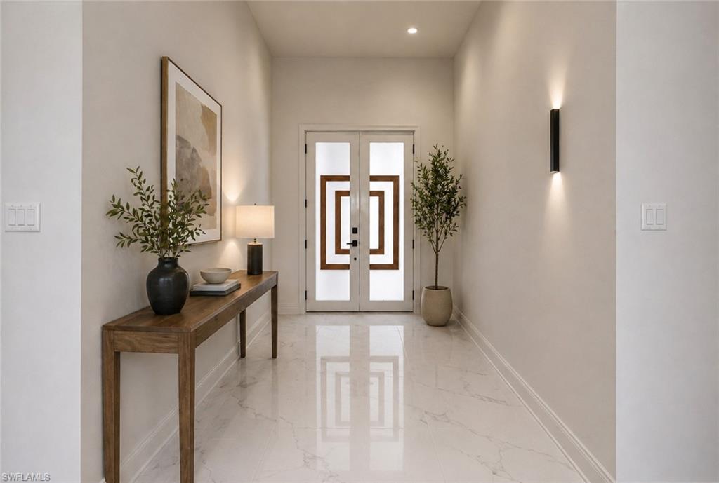 Entryway featuring large format marble-look tile flooring. Image digitally enhanced and virtually altered; actual property condition may differ.