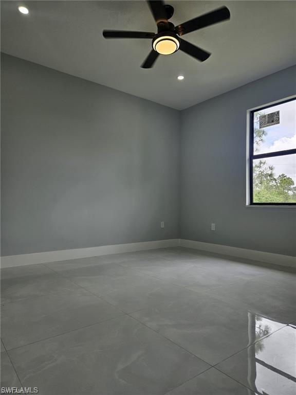 Unfurnished room with concrete floors, baseboards, recessed lighting, and a ceiling fan