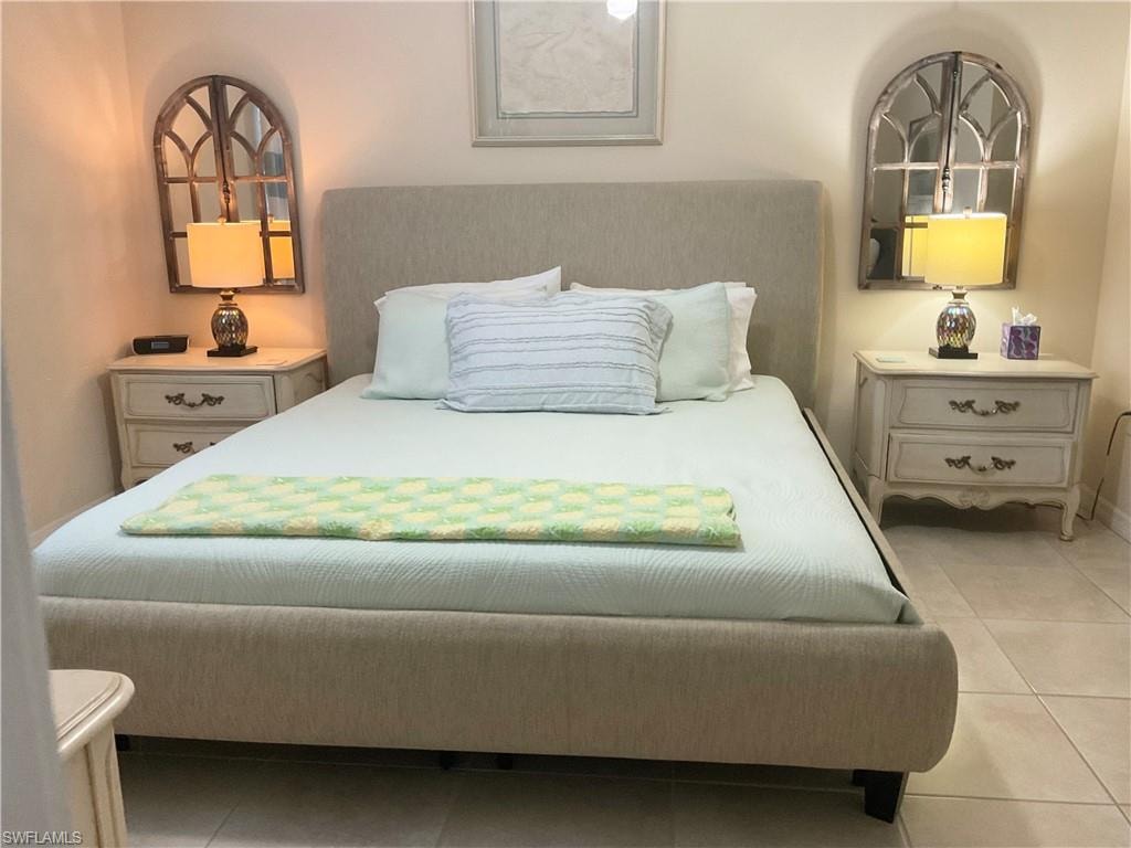Primary bedroom with king bed and tile flooring